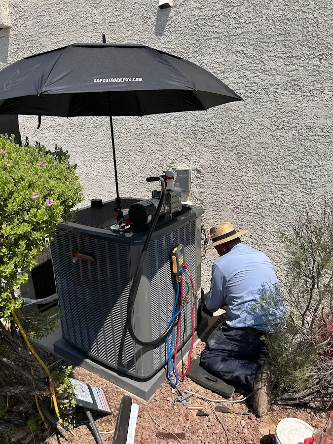 HVAC technician performing outdoor AC maintenance in La Grange